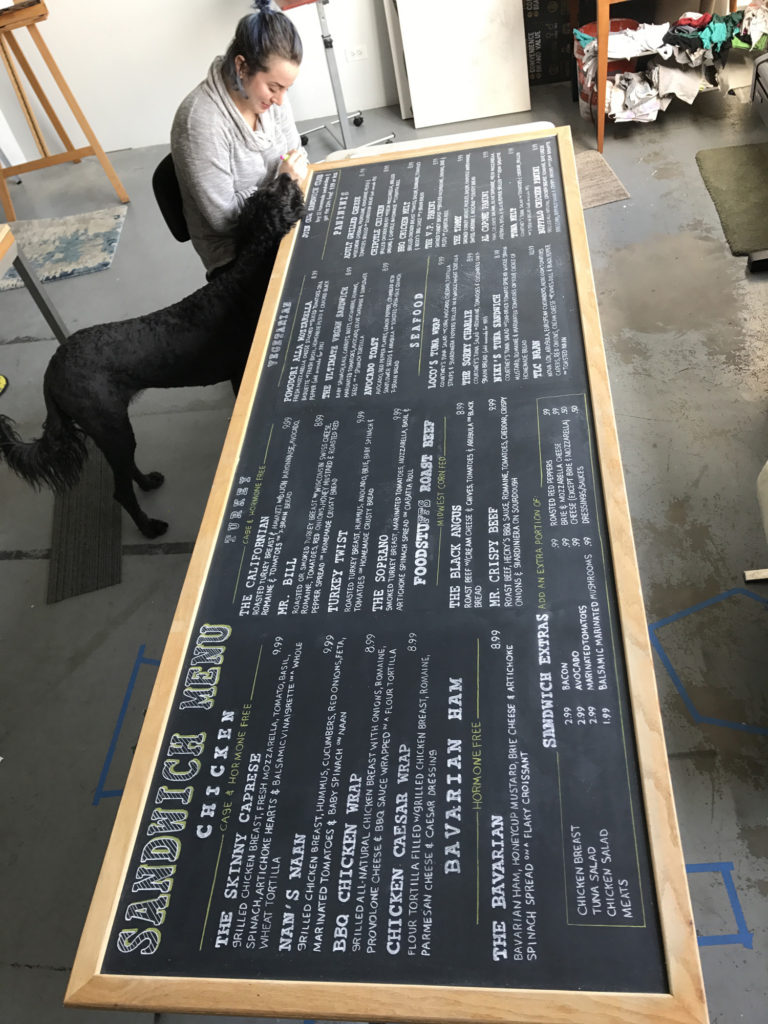 NPB Studio artist creating chalkboard menu