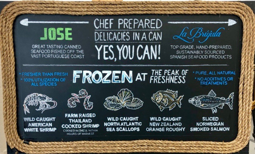 Chalkboard menu featuring frozen fish items in text with corresponding images