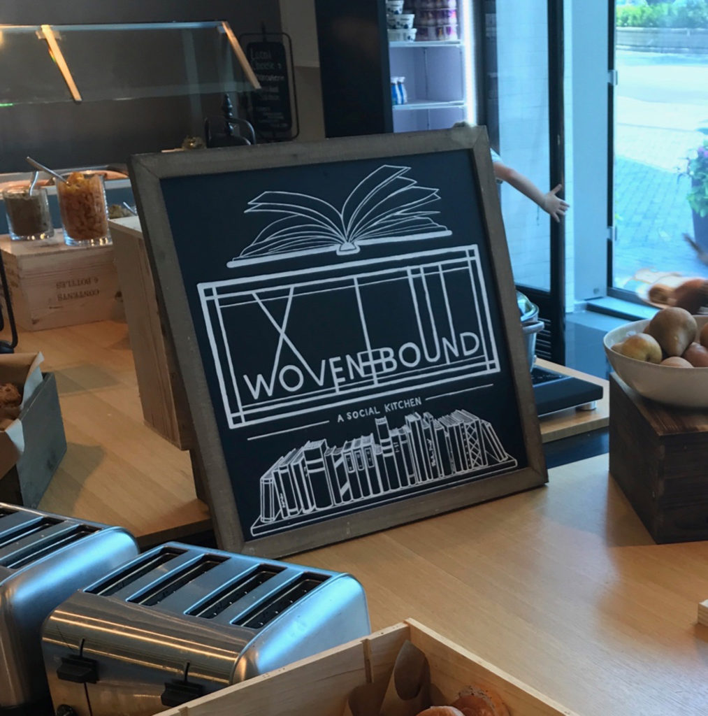 Chalkboard with Woven + Bound logo and images of books on a shelf